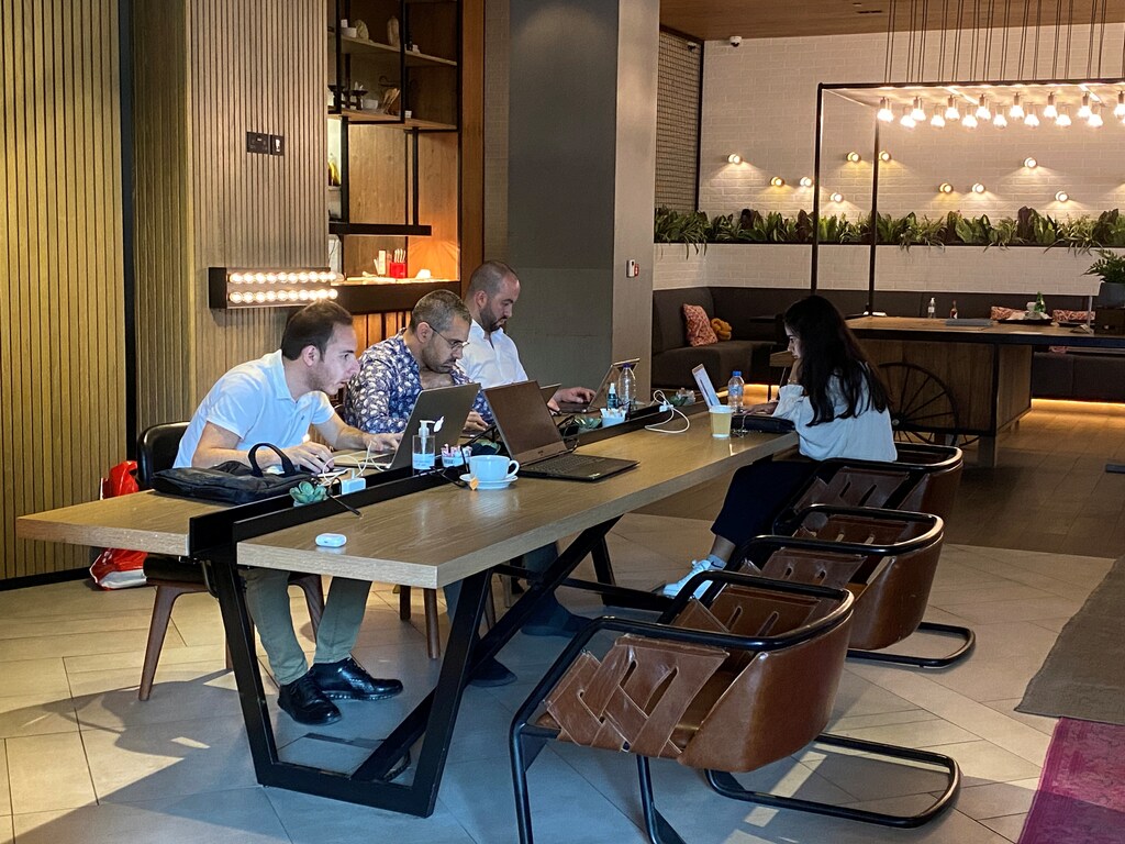 People work as they sit in a cafe at Zabeel House - The Greens, amid the spread of the coronavirus disease (COVID-19) in Dubai, United Arab Emirates February 1, 2021. Picture taken February 1, 2021. REUTERS/Rula Rouhana - RC2UKL9PEICV