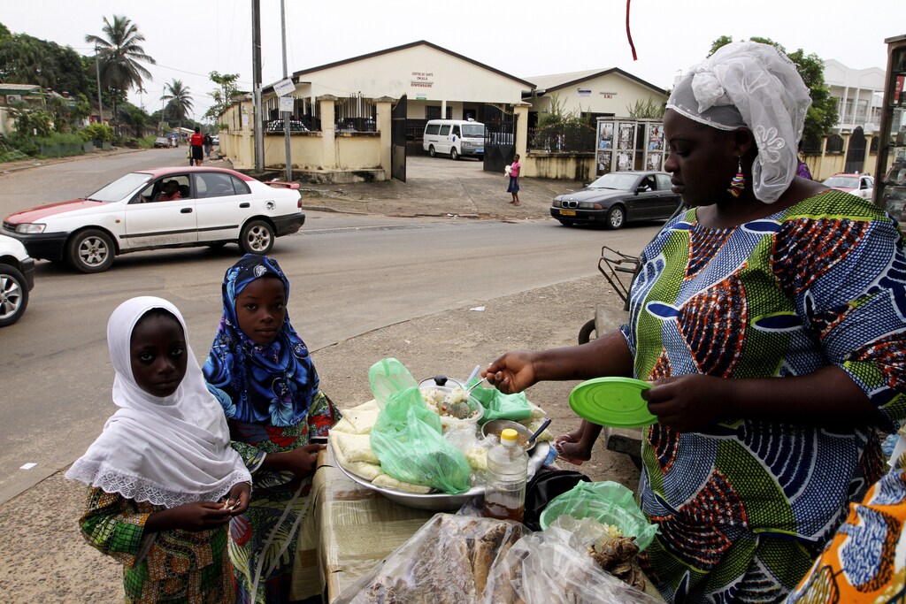 Muslim girls buy food from a street vendor at Okala, an area of Libreville February 14, 2012.