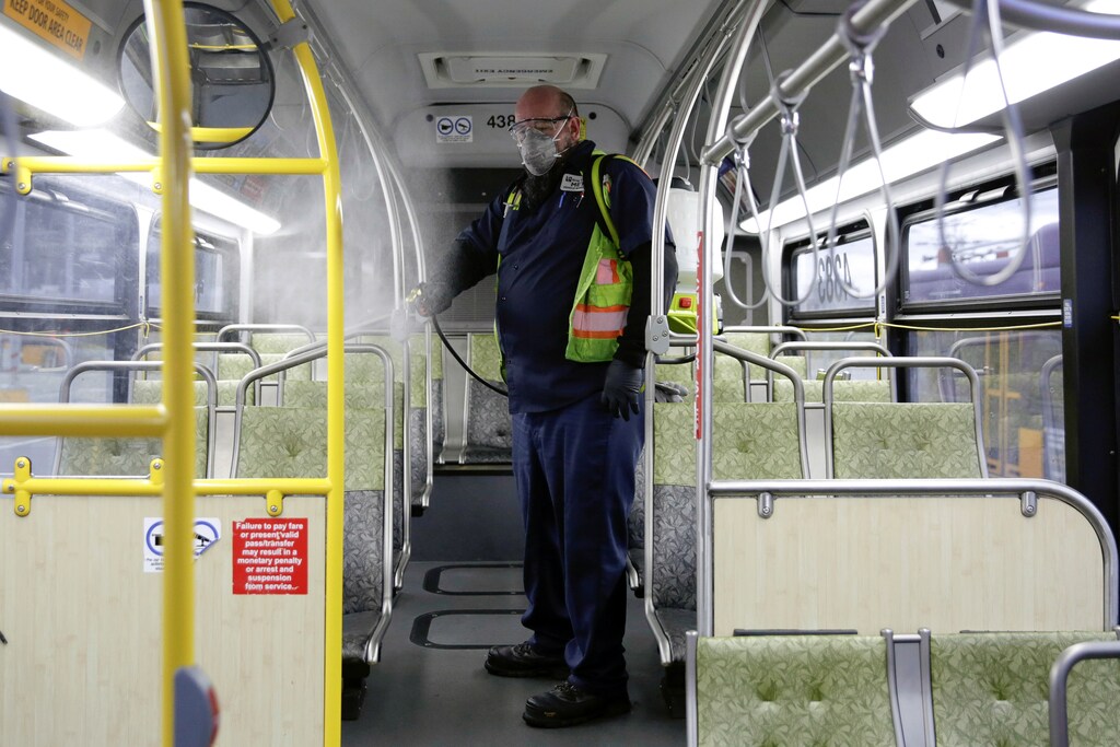 Raymond Determann, a King County Metro equipment service worker, sprays a Virex solution to sanitize buses against the coronavirus in Seattle, Washington, U.S. March 5, 2020. REUTERS/Jason Redmond - RC23EF9SGN94