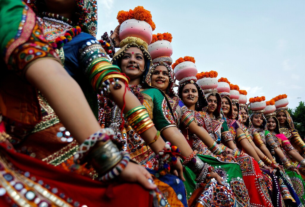 Women dressed in traditional attire pose after taking part in rehearsals for Garba, a folk dance, ahead of Navratri, a festival when devotees worship the Hindu goddess Durga, in Ahmedabad, India, September 25, 2016. REUTERS/Amit Dave TPX IMAGES OF THE DAY - S1BEUDHASCAB