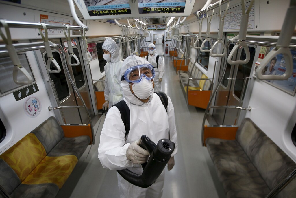 Workers disinfect the interior of a Seoul subway train during the 2015 MERS outbreak.