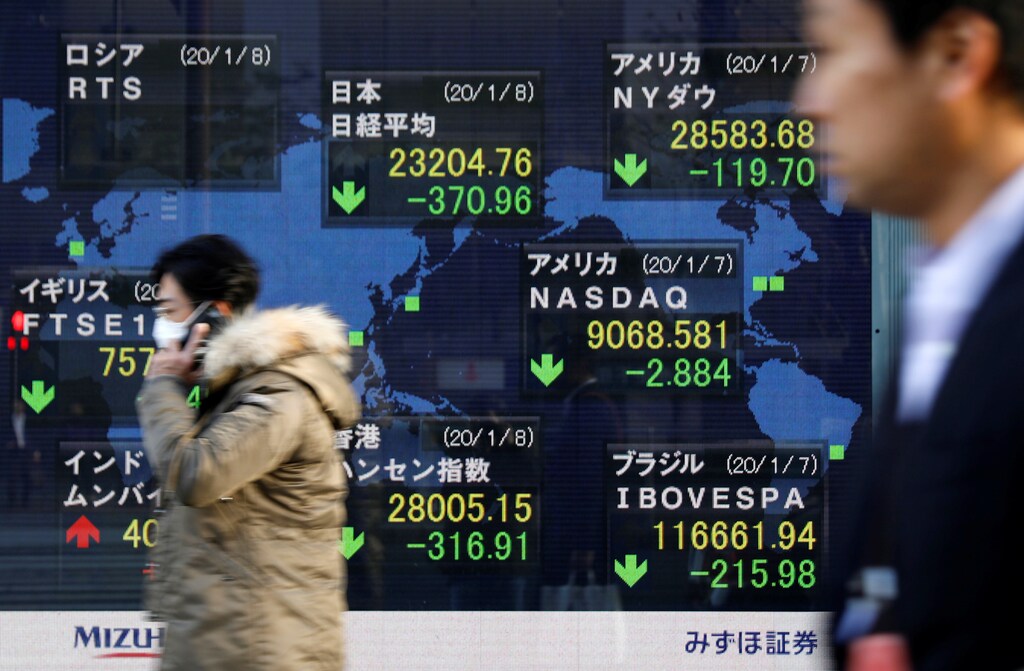People walk past an electronic display showing world markets indices outside a brokerage in Tokyo, Japan, January 8, 2020. REUTERS/Issei Kato - RC2JBE9XUJC6