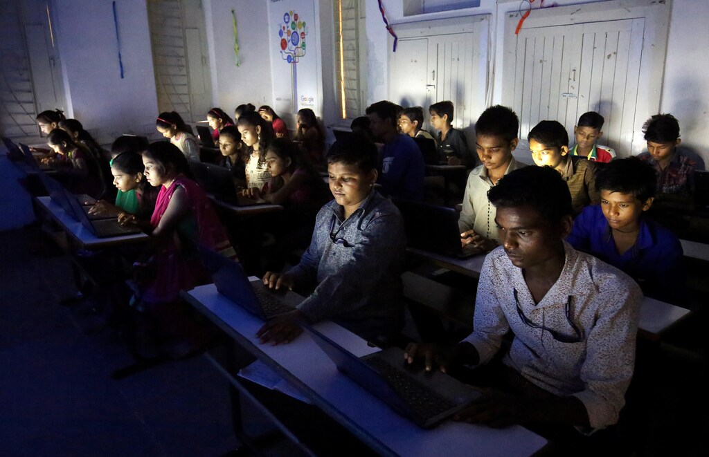 Students from low-income backgrounds study in an e-classroom at a government-run school in Ahmedabad, India.