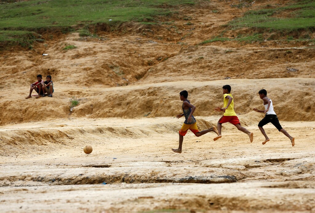 Rohingya refugee boys play football at the Kutupalang Makeshift Refugee Camp in Cox's Bazar, Bangladesh, July 8, 2017. REUTERS/Mohammad Ponir Hossain - RTX3ANOJ