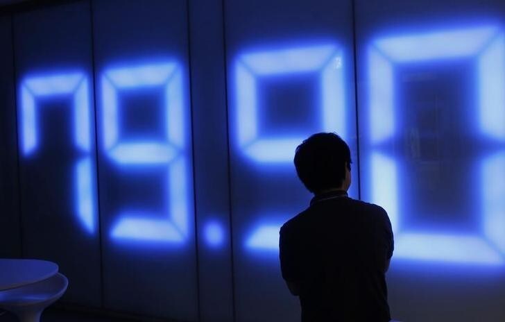 An employee of a foreign exchange trading company looks at a monitor showing the Japanese yen's exchange rate against the U.S. dollar in Tokyo August 4, 2011. Japan sold one trillion yen ($12.6 billion) and its central bank eased monetary policy on Thursday, joining Switzerland in efforts to tame currencies buoyed by safe-haven demand from investors fretting about the health of the global economy. REUTERS/Kim Kyung-Hoon (JAPAN - Tags: BUSINESS POLITICS)
