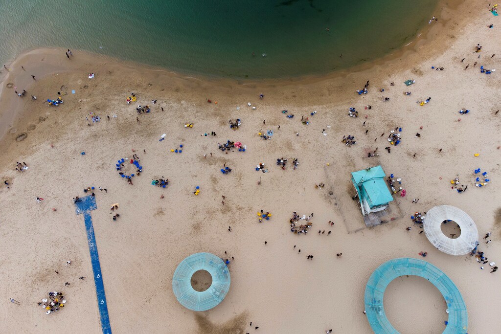 Israelis enjoy the beach of the Mediterranean during a heat wave as coronavirus disease (COVID-19) restrictions ease around the country, in Ashkelon Israel April 19, 2021. Picture taken with a drone. REUTERS/Amir Cohen - RC26ZM9KV543