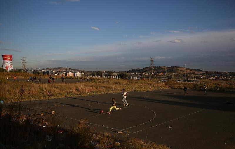 Boys play soccer at a makeshift pitch in Soweto, South Africa, May 14, 2018.