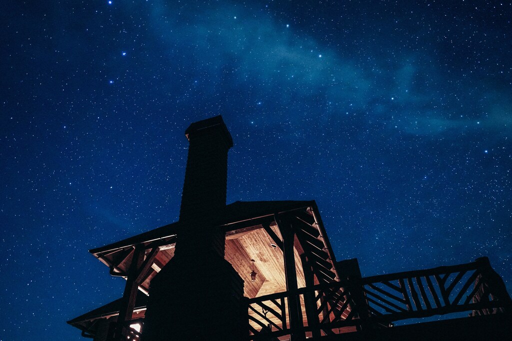 Sleep: A cabin with a starry night sky in the background.