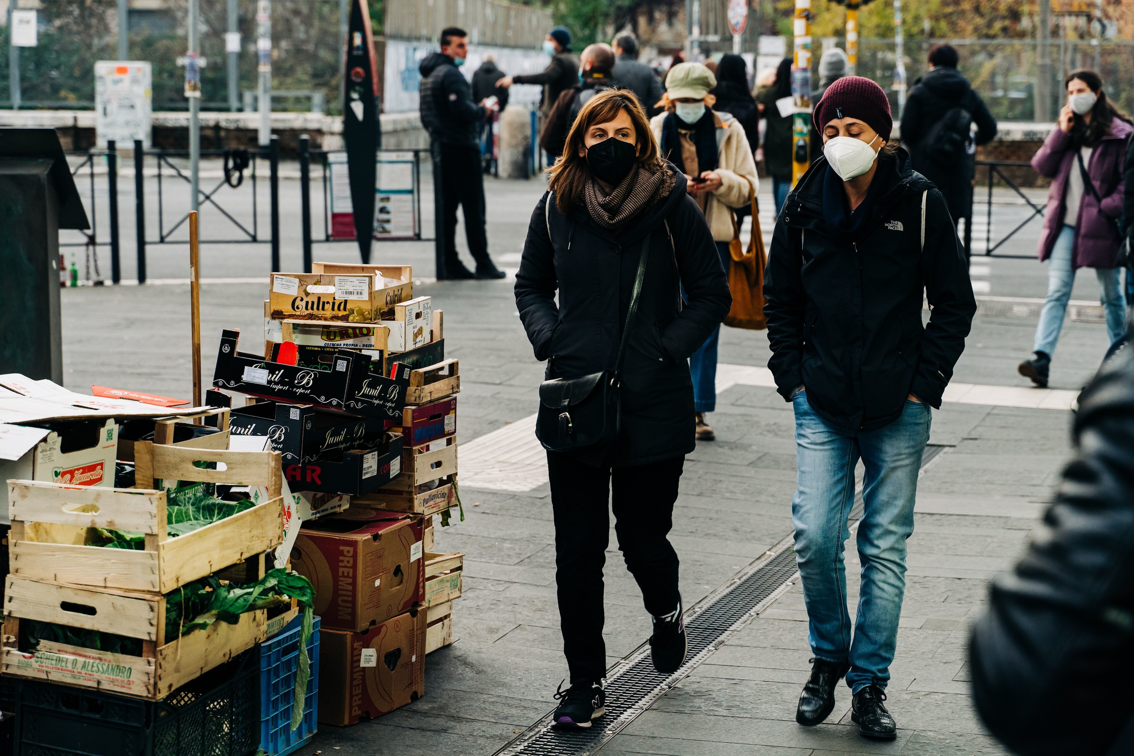 People walking on a street wearing face masks