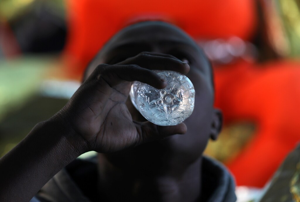 A migrant drinks water onboard the former fishing trawler Golfo Azzurro after he was rescued along with other migrants, including children and pregnant women, by the Spanish NGO Proactiva Open Arms as the raft he was on drifted out of contol in the central Mediterranean Sea, some 36 nautical miles off the Libyan coast, January 3, 2017. REUTERS/Yannis Behrakis - RTX2XBY3