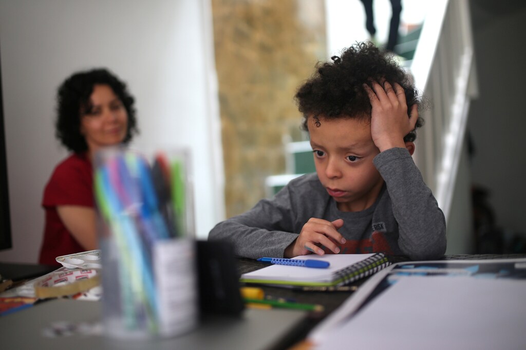 Martin Vernaza, 8, studies at home after school closes during the mandatory isolation decreed by the Colombian government as a preventive measure against the spread of the coronavirus disease (COVID-19), in Bogota, Colombia April 2, 2020. REUTERS/Luisa Gonzalez - RC2JWF9JOGGJ