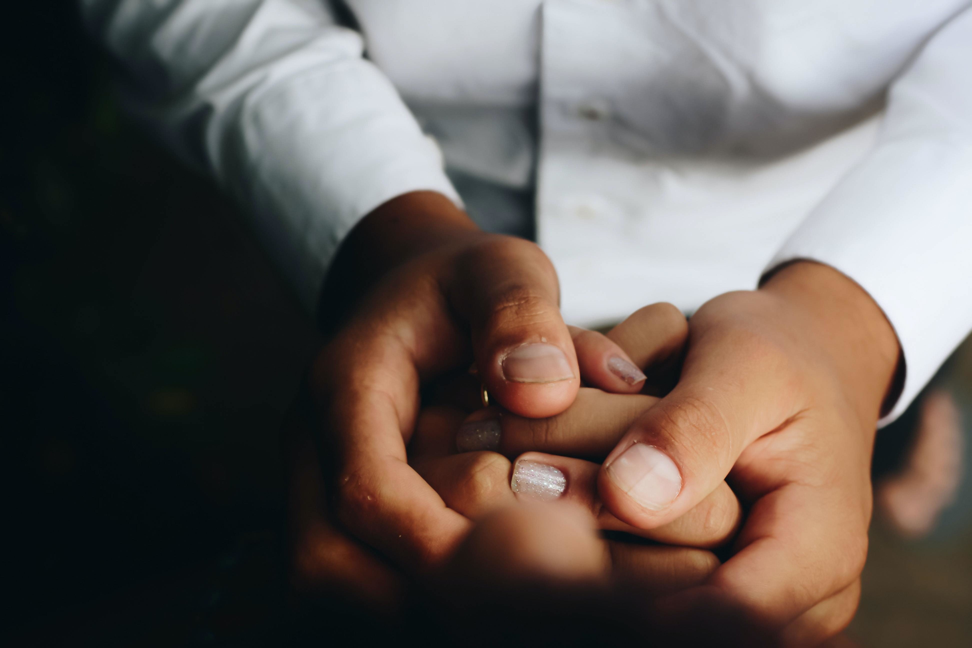 Meaningful participation matters in principle and works in practice. Pictured: one person holds the hands of another