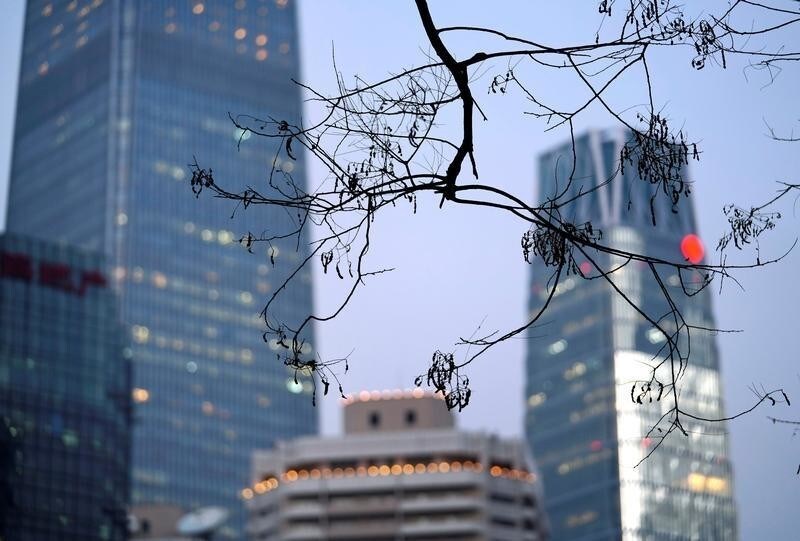 Branches are pictured in front of buildings in Beijing's central business area, China December 14, 2017. REUTERS/Jason Lee - RC14ED52C7F0