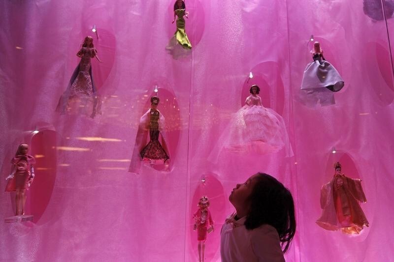 A child looks at Barbie dolls on a display during the opening ceremony of Barbie Shanghai flagship store in Shanghai March 6, 2009. REUTERS/Aly Song (CHINA) - GM1E53701WO01
