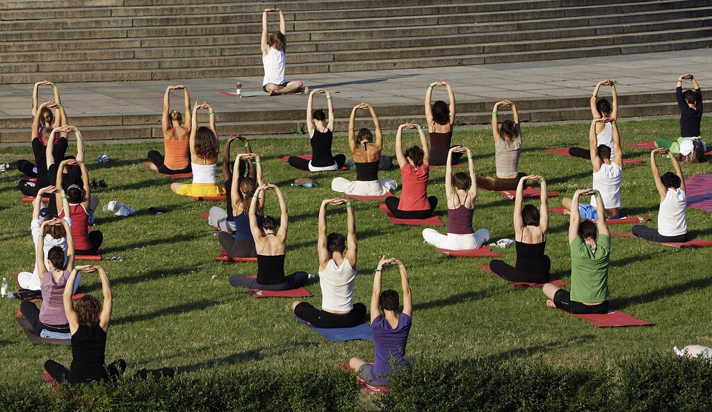 Yoga enthusiasts perform an open air class in front of victory column 'Siegessaeule' in Berlin July 1, 2008.