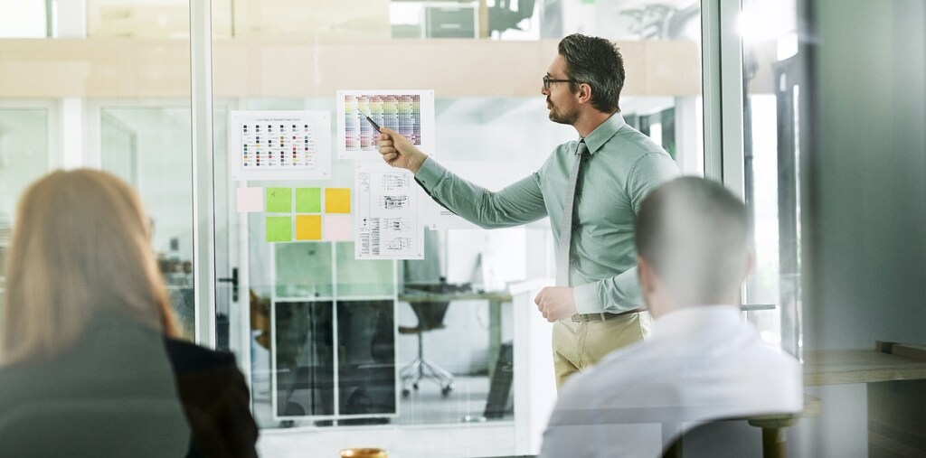 Shot of a businessman giving a presentation to his colleagues in an office. The private sector will play a pivotal role in achieving the UN's Sustainable Development Goals (SDGs)