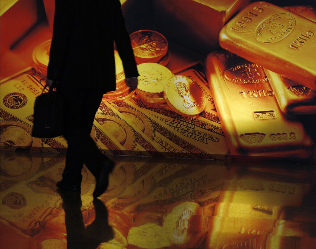 A participant walks past a poster at the Asian Financial Forum in Hong Kong January 20, 2010.
