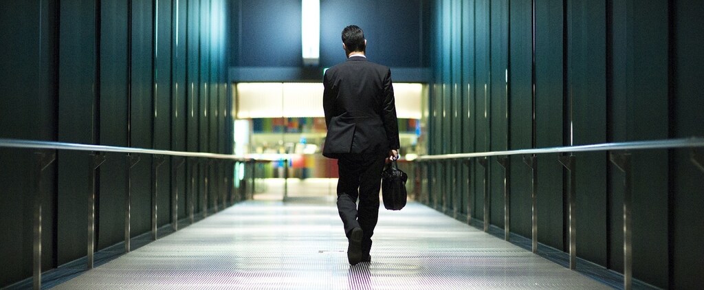 A businessman walks through the Tokyo International Forum in a banking district in central Tokyo November 27, 2014. Japan's jobless rate fell and the availability of jobs edged higher in October from the previous month, government data released on Friday showed. Picture taken November 27, 2014. REUTERS/Thomas Peter (JAPAN - Tags: BUSINESS EMPLOYMENT) - RTR4FW45