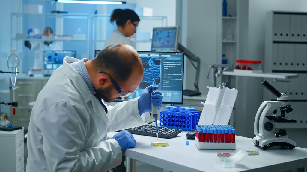 gene therapy - Scientist putting blood sample from test tube with micropipette in petri dish analysing chemical reaction. Lab technician examining virus evolution using high tech and tools for vaccine development