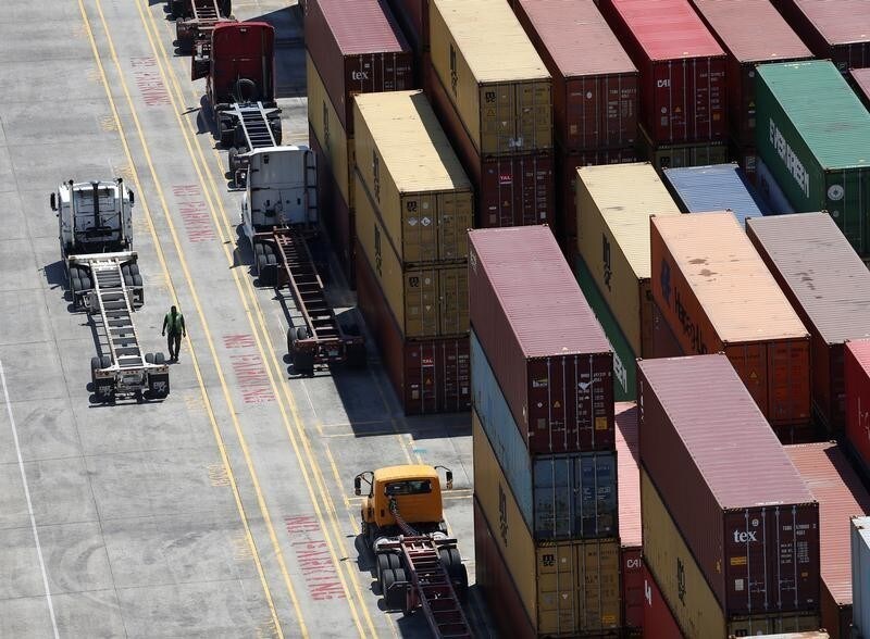 Workers stack empty shipping containers for storage at Wando Welch Terminal operated by the South Carolina Ports Authority in Mount Pleasant, South Carolina, U.S. May 10, 2018. Picture taken May 10, 2018. REUTERS/Randall Hill - RC1212BAF590
