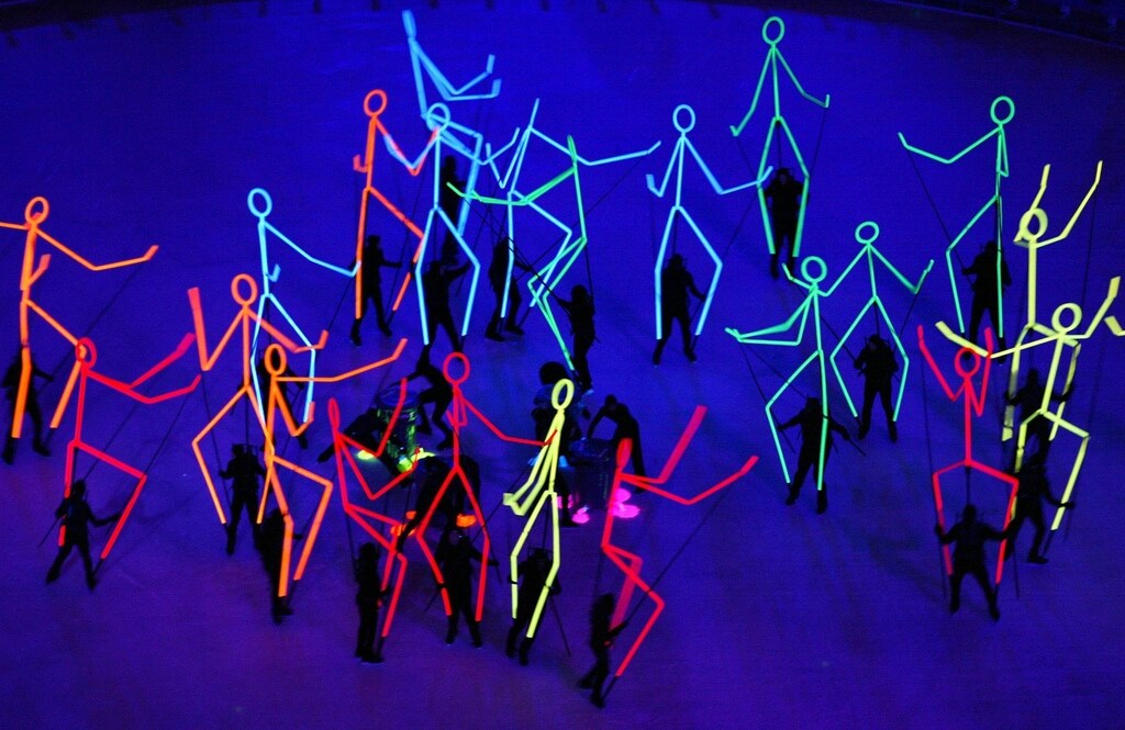 Flourescent stick figures are carried around as part of the ultraviolet segment of the closing ceremony of the Salt Lake 2002 Olympic Winter Games, February 24, 2002. [The XX Olympic Winter Games will be held in Turin, Italy, in 2006.] - PBEAHUKTWAF