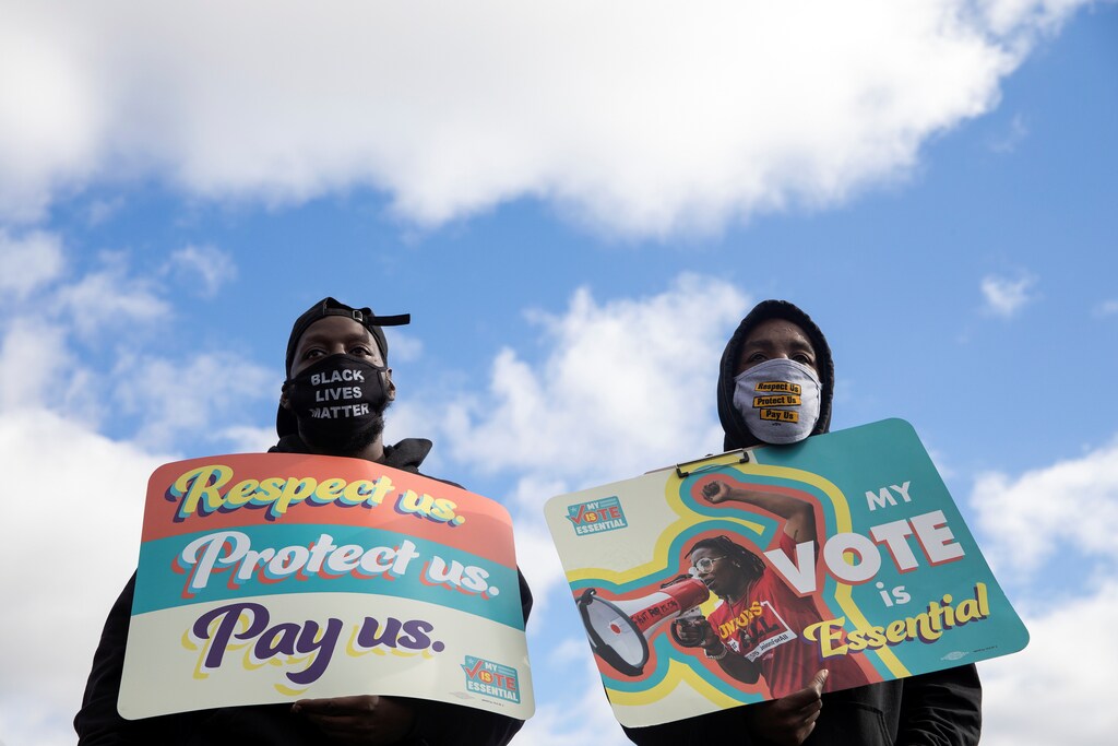 People join fast-food and nursing home workers during a "My Vote is Essential" rally before casting their early ballots, amid the coronavirus disease (COVID-19) concerns at Wayne County Community College in Detroit, Michigan, U.S., October 24, 2020. REUTERS/Emily Elconin - RC26PJ9M0LAO