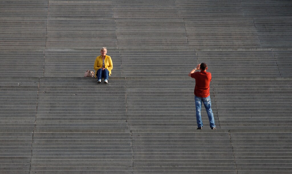 A man takes picture of a woman at the Chkalov Staircase in Nizhny Novgorod, Russia, August 26, 2017. REUTERS/Maxim Shemetov - RC122BE6CE00