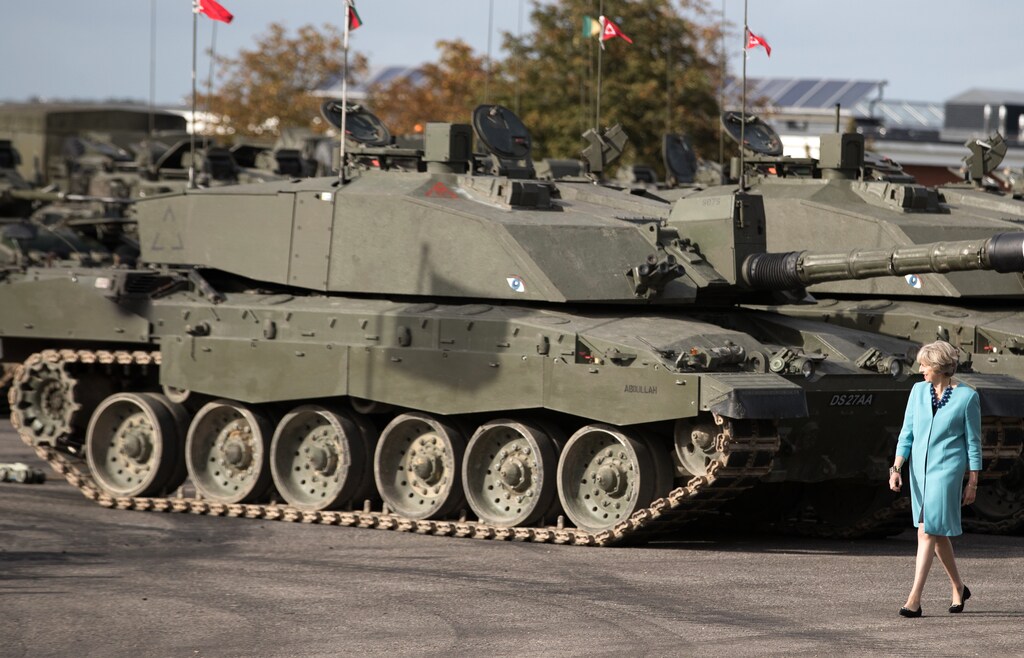 Prime Minister Theresa May passes tanks as she visits 1st Battalion The Mercian Regiment (Cheshire, Worcesters and Foresters, and Staffords) at their barracks at Bulford Camp on September 29, 2016 near Salisbury, England. The Prime Minister visited the military base in the Salisbury Plain area to meet with soldiers, see the equipment they work with and to also meet with some their families. REUTERS/Matt Cardy/Pool - LR1EC9T190RK3