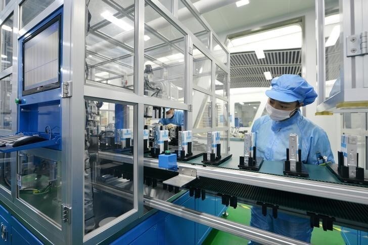 Workers are seen at the production line of lithium-ion batteries for electric vehicles (EV) at a factory in Huzhou, Zhejiang province, China August 28, 2018. REUTERS/Stringer ATTENTION EDITORS - THIS IMAGE WAS PROVIDED BY A THIRD PARTY. CHINA OUT.