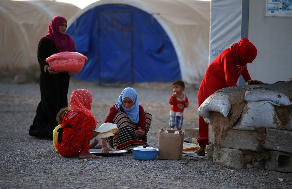 Evacuees make bread inside a refugee camp for people who fled from Mosul due to fighting between Iraqi forces and Islamic State militants, in the outskirts of Erbil, Iraq June 10, 2017. REUTERS/Erik De Castro - RTS16IH0