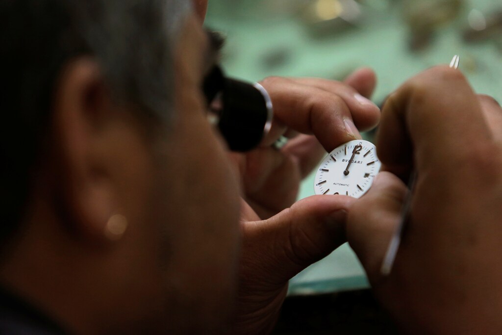 A watch repairer looks at the watch face while doing adjustments at a workshop in Mexico City, Mexico January 25, 2018. REUTERS/Daniel Becerril - RC1F4CDF7C70