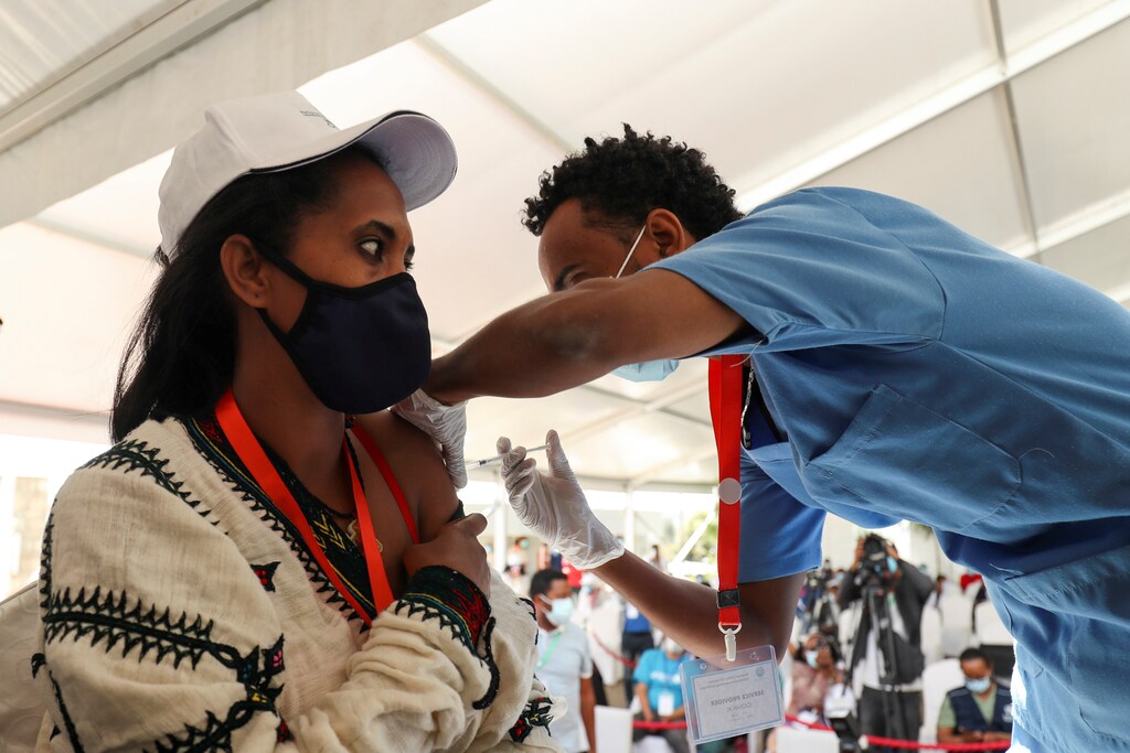 A woman receives the AstraZeneca/Oxford vaccine under the COVAX scheme against the coronavirus disease (COVID-19) at the Eka Kotebe General Hospital in Addis Ababa, Ethiopia March 13, 2021. REUTERS/Tiksa Negeri - RC2AAM9QQ26Y