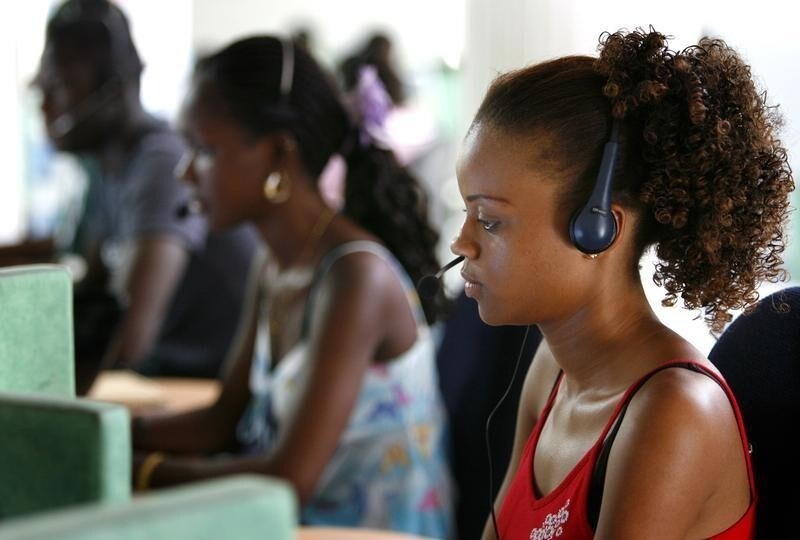 Ndeye Astou Fall, 22, works at a call centre in Senegal's capital Dakar, June 23, 2006. With some of the best telecommunications on the continent, plenty of cheap labour, strong historic links with France and relative political stability, Senegal is increasingly taking on Morocco and Tunisia in the battle for the French call centre outsourcing market.REUTERS/Finbarr O'Reilly (SENEGAL) - RTR1ES7A