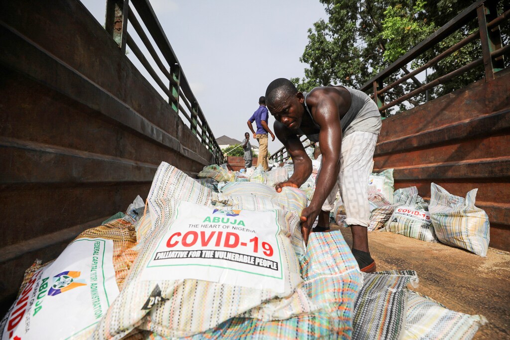 Men load sacks of rice among other food aid in a truck, to be distributed for those affected by procedures taken to curb the spread of coronavirus disease (COVID-19), in Abuja, Nigeria April 17, 2020. Picture taken April 17, 2020.