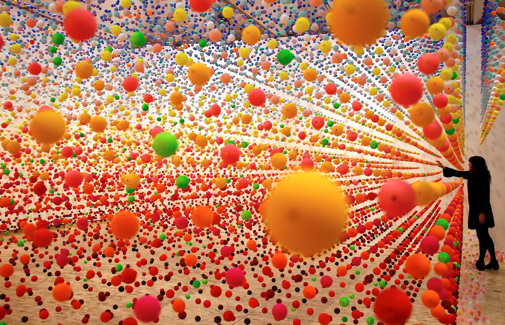 Australian artist Nike Savvas adjusts her installation artwork piece, consisiting of over 50,000 polystyrene balls, titled 'Atomic: full of love full of wonder' as it is installed for the upcoming exhibition 'Spacemakers and roomshakers: installations from the collection' at the New South Wales Art Gallery in Sydney, Australia, July 12, 2018. Picture taken July 12, 2018. REUTERS/David Gray TPX IMAGES OF THE DAY - RC15CC7233E0