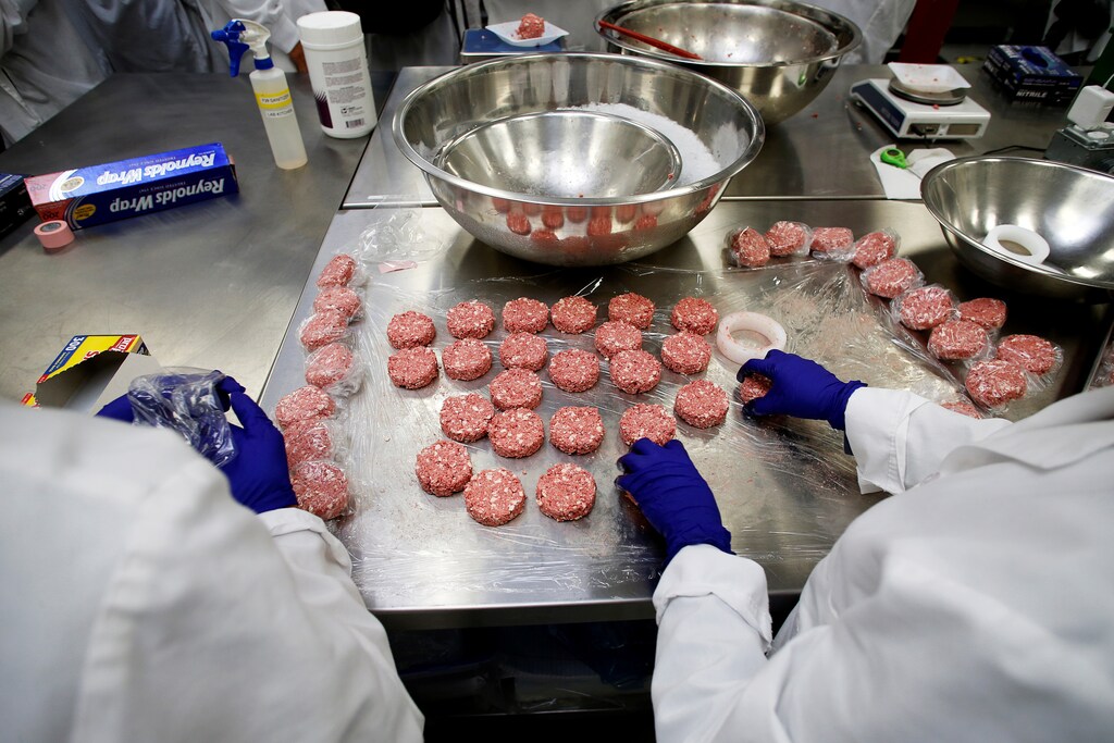 Workers assemble the plant-based hamburger patties during a media tour of Impossible Foods labs and processing plant in Redwood City, California, U.S. October 6, 2016. Picture taken October 6, 2016. REUTERS/Beck Diefenbach - RTSS2U1
