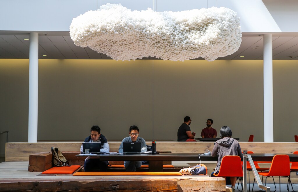 People worked in the lobby of the Airbnb office headquarters in the SOMA district of San Francisco, California, U.S., August 2, 2016. REUTERS/Gabrielle Lurie - RTX38KF8