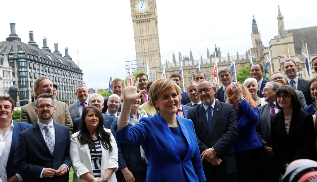 Scotland's First Minister and leader of the Scottish National Party Nicola Sturgeon waves as she poses with her party's Members of Parliament in London, Britain, June 12, 2017.