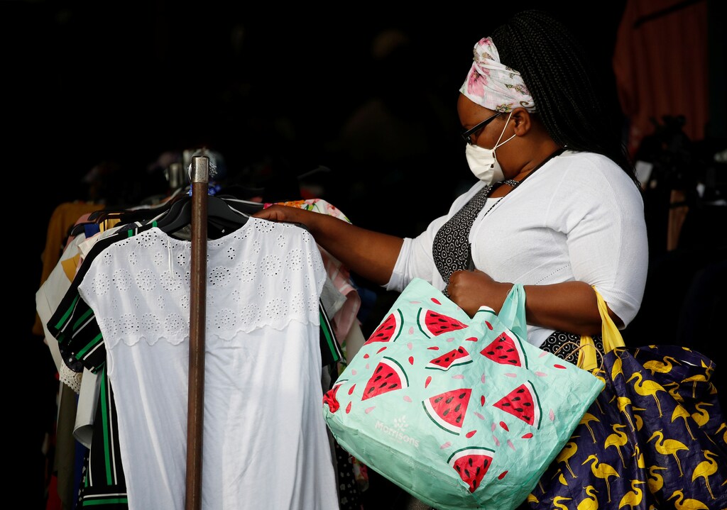 A woman wears a face mask as she shops at a clothes stall in a market following the outbreak of the coronavirus disease (COVID-19) in Bolton, Britain, September 15, 2020. REUTERS/Phil Noble - RC2YYI9ETGXL
