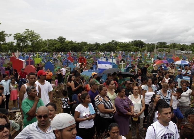 People attend a funeral ceremonies for the victims of a building fire that occurred on Saturday, in Managua, Nicaragua, June 17, 2018.