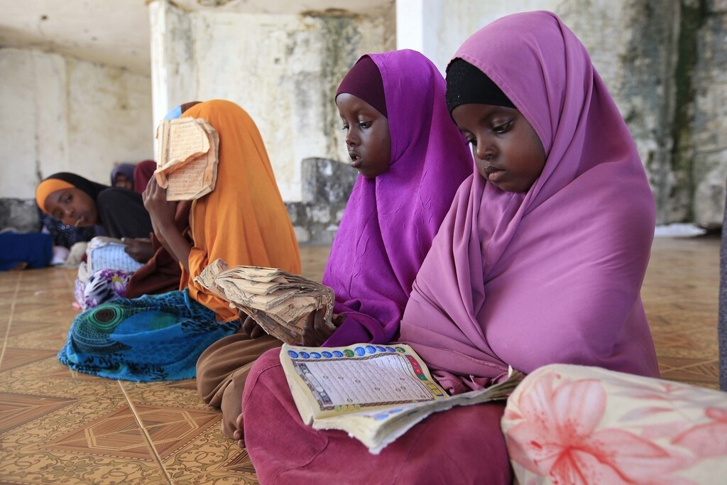 Children read during a Koranic studies lesson inside a classroom in the Hodan area of Mogadishu September 25, 2013. Street lamps now brighten some of Mogadishu's battle-scarred roads and couples hold hands at the seaside next to bombed-out beachfront buildings, a scene that would have been unthinkable when the Islamist al Shabaab group held sway here. However, rebuilding a life many in the world take for granted is a slow process after more than 20 years of civil war and anarchy in Somalia. Islamists, who control swathes of countryside and some towns, have launched several attacks in Mogadishu, and last month they showed their reach, claiming responsibility for a deadly attack on a Kenyan shopping mall. Picture taken September 25, 2013.