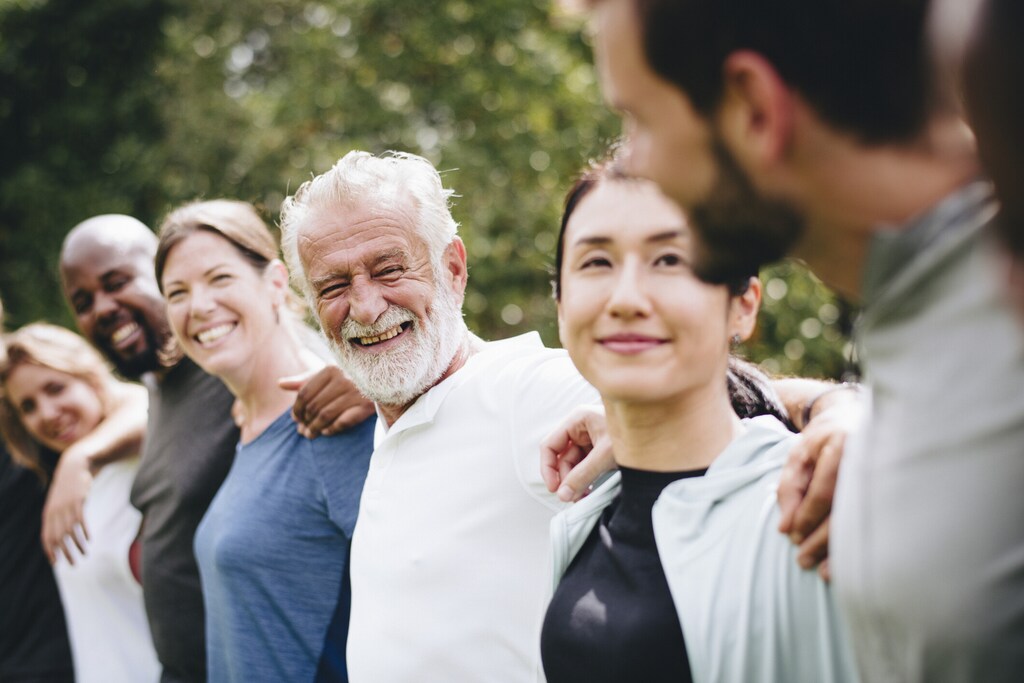 Happy diverse people together in the park; mental health and wellbeing