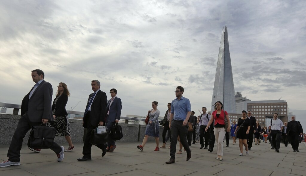 Commuters walk across London Bridge to the City of London August 7, 2013.
