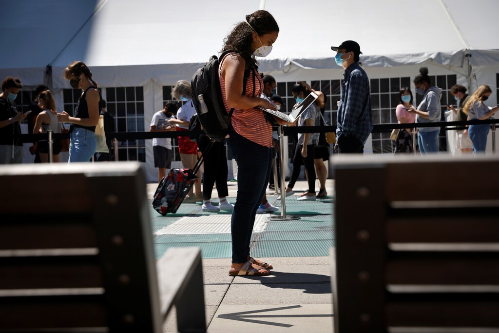 People wear protective masks as they wait in line at a testing site for the coronavirus disease (COVID-19) set up for returning students, faculty and staff on the main New York University (NYU) campus in Manhattan, New York City, New York, U.S., August 18, 2020. REUTERS/Mike Segar - RC2HGI9J7DIH