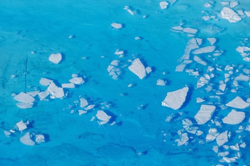 Chunks of ice float inside of meltwater pools on top of the Helheim glacier near Tasiilaq, Greenland, June 19, 2018. REUTERS/Lucas Jackson - RC1434C79680