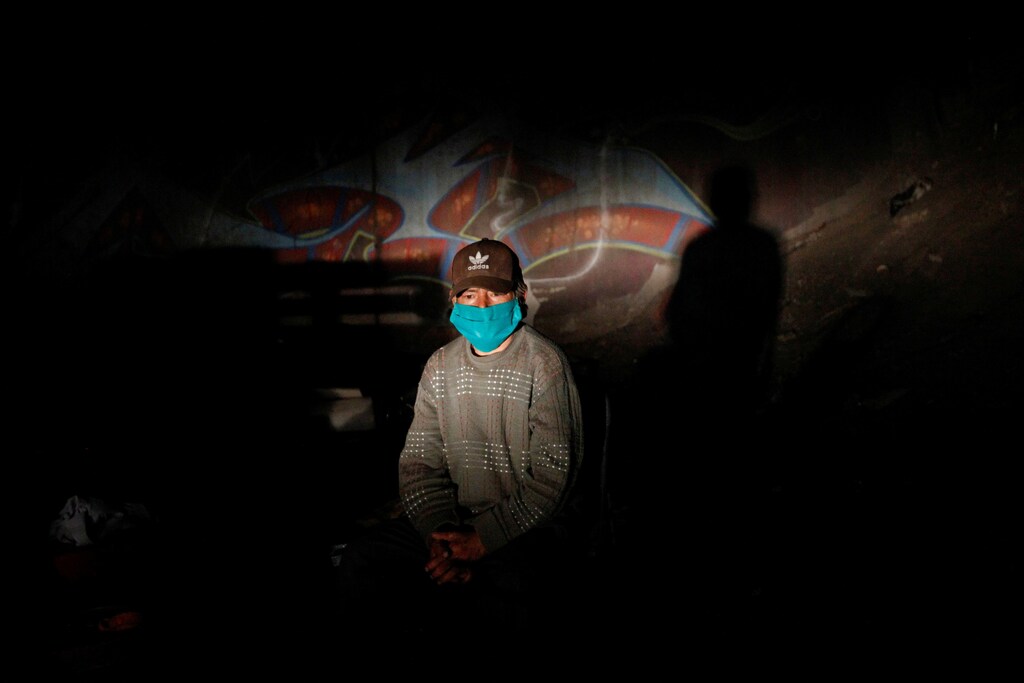 A homeless man is seen while he waiting to receive food delivered by volunteers, following the outbreak of the coronavirus disease (COVID-19) in Santiago, Chile April 23, 2020. Picture taken April 23, 2020. REUTERS/Carlos Vera TPX IMAGES OF THE DAY - RC27BG9K4P9H