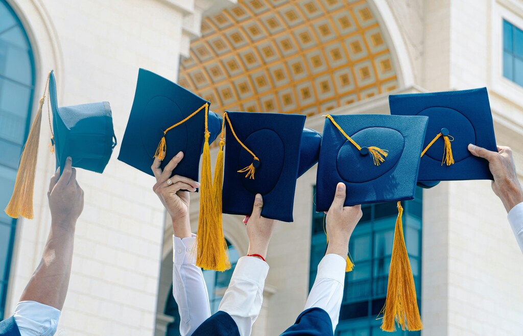HIgher education, graduation caps in the air