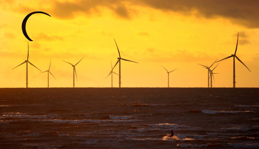 A man kite surfs in front of the Burbo Bank wind farm near New Brighton, Britain, September 3, 2018. REUTERS/Phil Noble TPX IMAGES OF THE DAY - RC11419D7E10