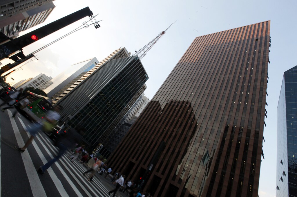 Pedestrians walk across Paulista Avenue in Sao Paulo's financial district