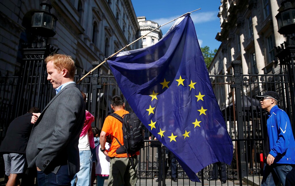 man carries a EU flag, after Britain voted to leave the European Union, outside Downing Street in London, Britain June 24, 2016.